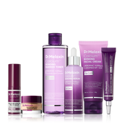 Mehrteiliges Gesichtspflege-Set mit Toner, Serum, Cremes und Pflegestift in violetten und rosafarbenen Verpackungen