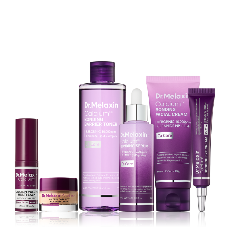 Mehrteiliges Gesichtspflege-Set mit Toner, Serum, Cremes und Pflegestift in violetten und rosafarbenen Verpackungen