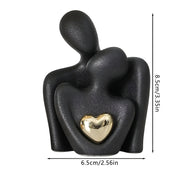 Stilisierte Paarfiguren aus Keramik mit glänzendem Herzdetail